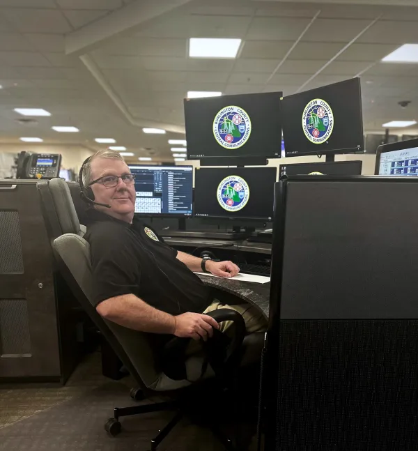 Member Bill Haines sitting at his dispatch desk