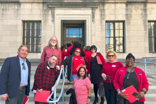 CWA staff and shop stewards smiling on the steps of the statehouse